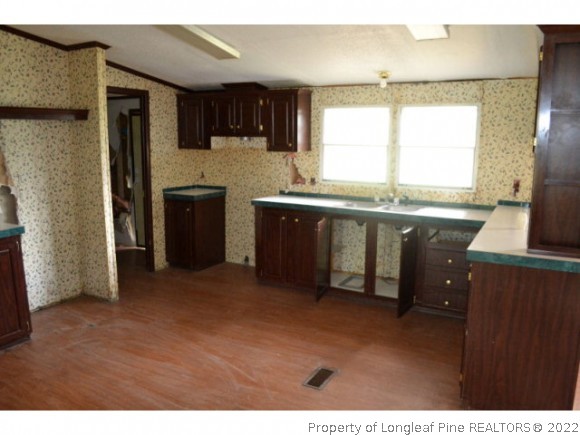 890 Maynard Lake Road Godwin, NC 28344 - Photo 4 of 7 a kitchen with stainless steel appliances granite countertop a refrigerator a sink dishwasher a stove with wooden cabinets