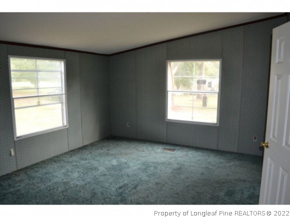 890 Maynard Lake Road Godwin, NC 28344 - Photo 5 of 7 a view of an empty room with a window