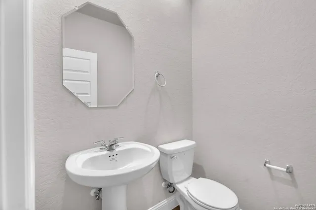 a bathroom with a sink a mirror and a toilet