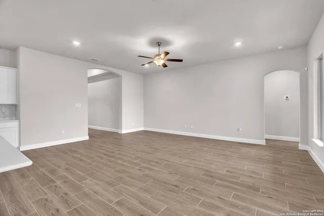 wooden floor in an empty room with a window