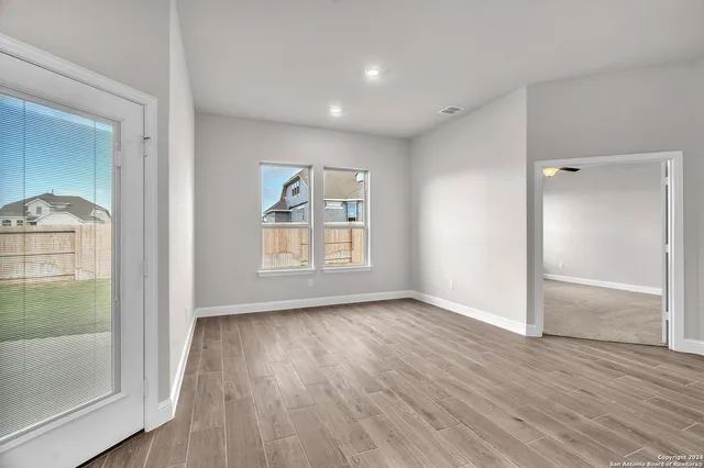 wooden floor in an empty room with a window