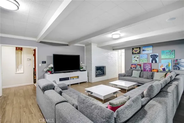 a bedroom with a large bed and wooden floor