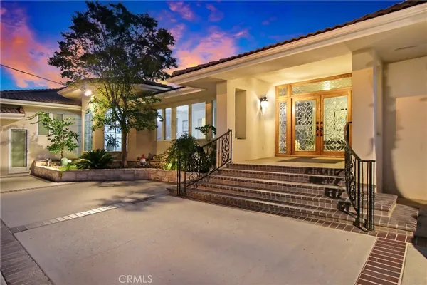 a view of a porch with a table and chairs and potted plants