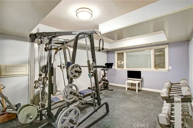 a bathroom with a granite countertop sink a large mirror and a toilet