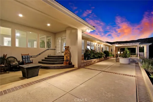 a view of a swimming pool with an outdoor seating