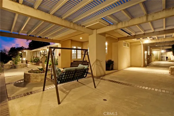 a view of a patio with table and chairs potted plants with wooden fence