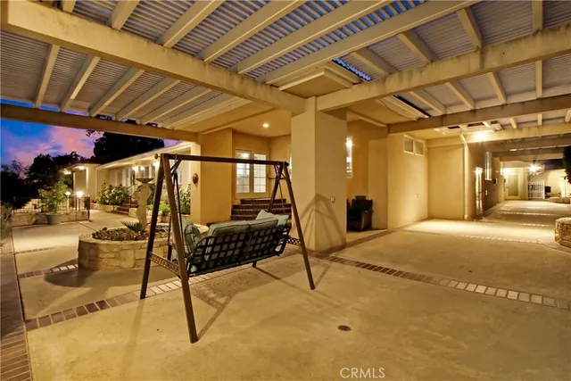 a view of a patio with table and chairs potted plants with wooden fence