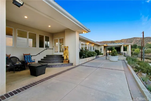 a view of a swimming pool with an outdoor seating
