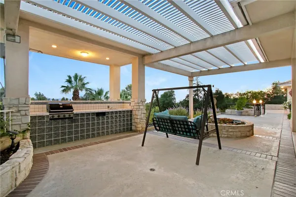 a front view of a house with a yard and potted plants