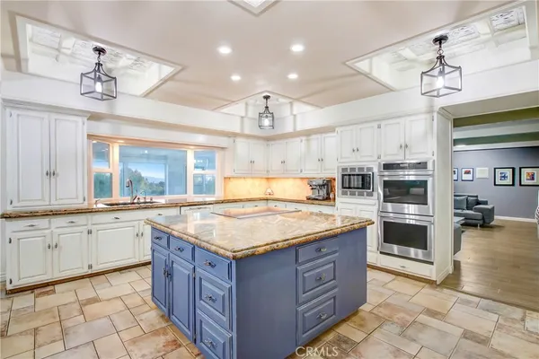 a kitchen with a stove top oven and cabinets