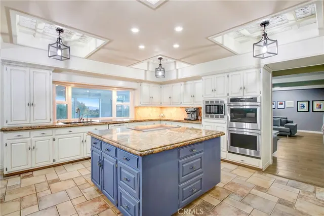 a kitchen with a stove top oven and cabinets