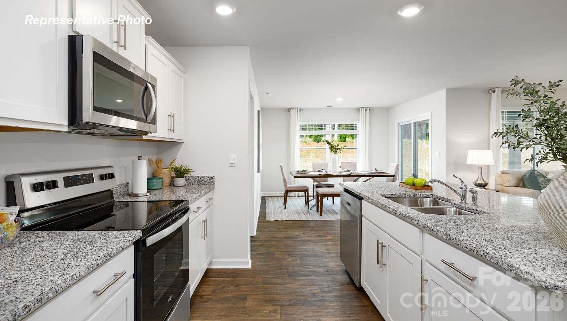 4552 Harris Elliot Road Lincolnton, NC 28092 - Photo 7 of 31 a kitchen with stainless steel appliances granite countertop a stove a sink and a microwave