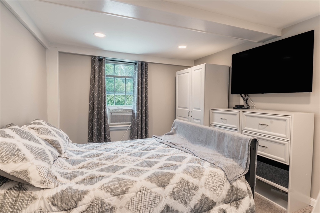 2 Kelsey Road Boxford, MA 01921 - Photo 12 of 42 a bedroom with a bed and a flat screen tv