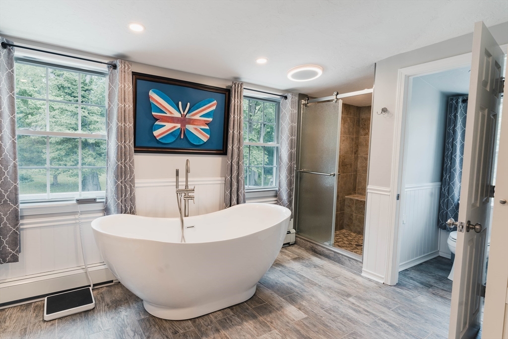 2 Kelsey Road Boxford, MA 01921 - Photo 19 of 42 a white bath tub sitting in a en suite bathroom next to a window