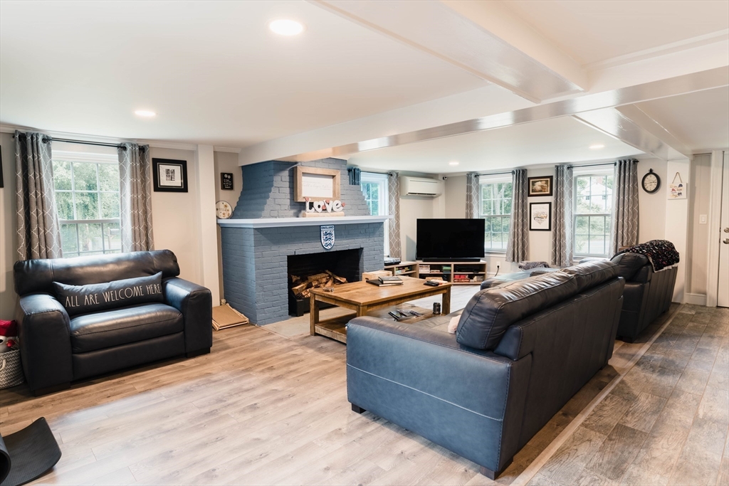 2 Kelsey Road Boxford, MA 01921 - Photo 3 of 42 a living room with furniture a flat screen tv and a fireplace