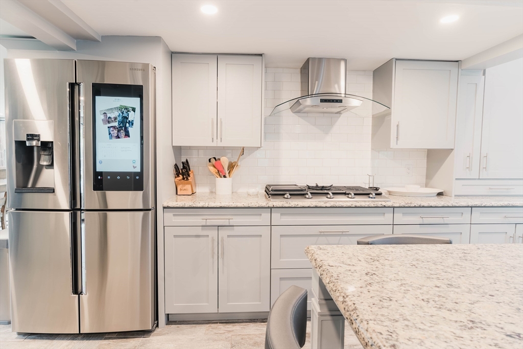 2 Kelsey Road Boxford, MA 01921 - Photo 4 of 42 a kitchen with stainless steel appliances granite countertop a refrigerator sink and stove