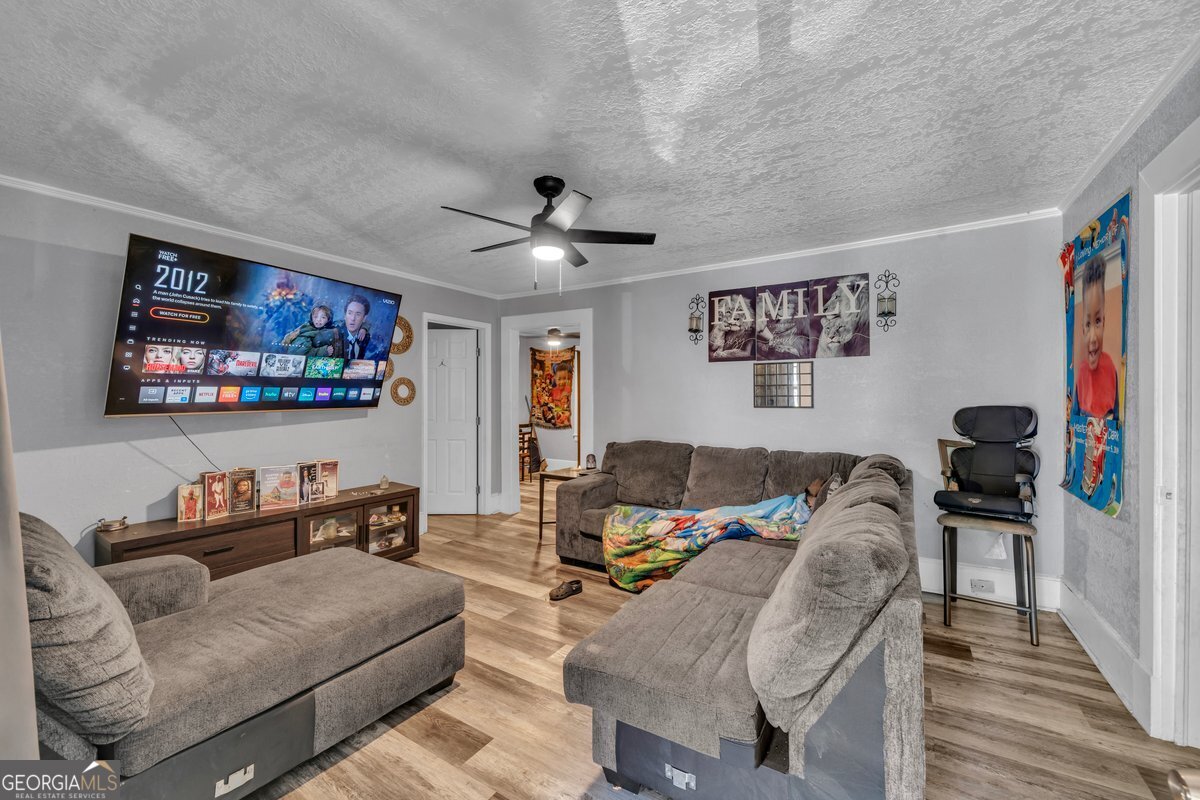 415 East 7th Avenue Cordele, GA 31015 - Photo 5 of 13 a living room with furniture and a flat screen tv