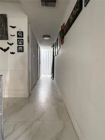 a view of a hallway with stairs