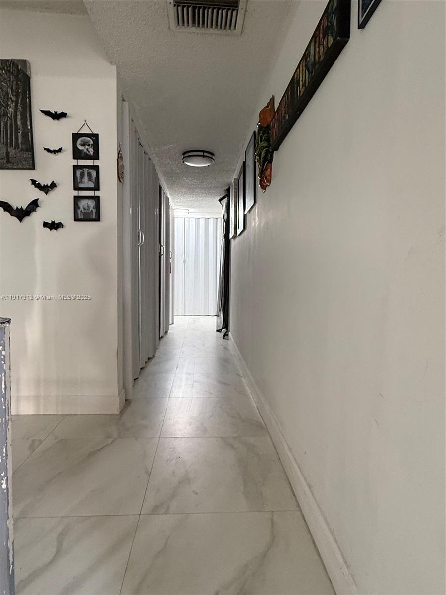 4850 Southwest 63rd Terrace, Unit 312 Davie, FL 33314 - Photo 11 of 27 a view of a hallway with stairs