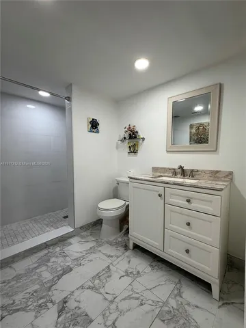 a spacious bathroom with a toilet sink and mirror