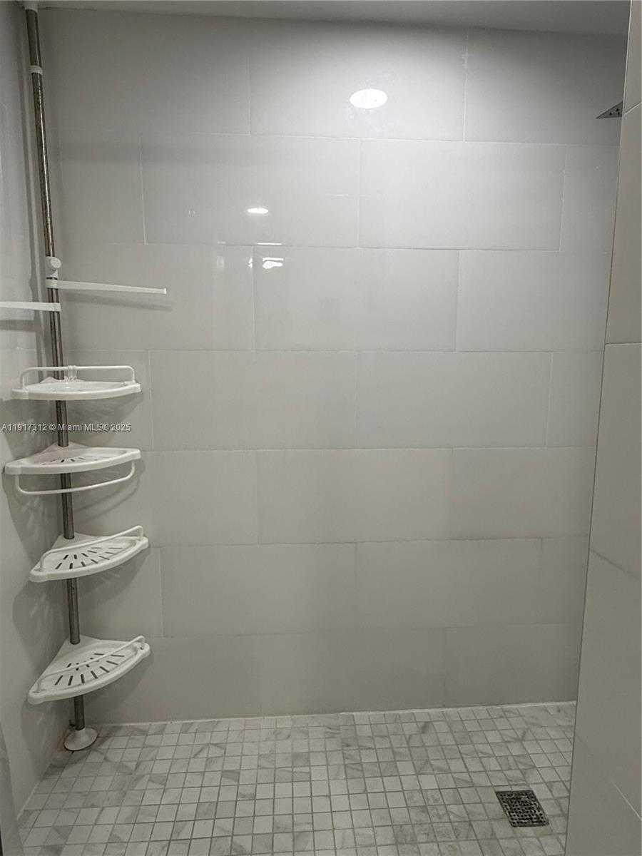 4850 Southwest 63rd Terrace, Unit 312 Davie, FL 33314 - Photo 16 of 27 a bathroom with a bathtub