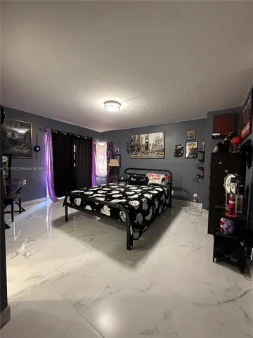 a bed room with a bed furniture and a flat screen tv