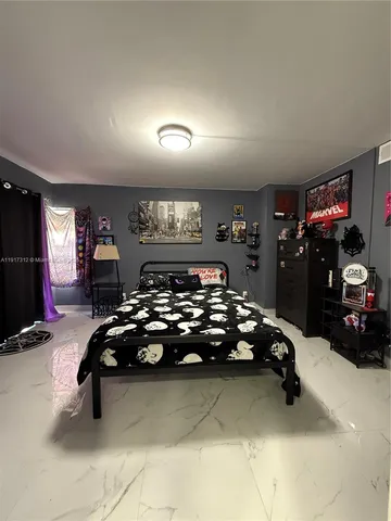 a bed room with furniture and a flat screen tv
