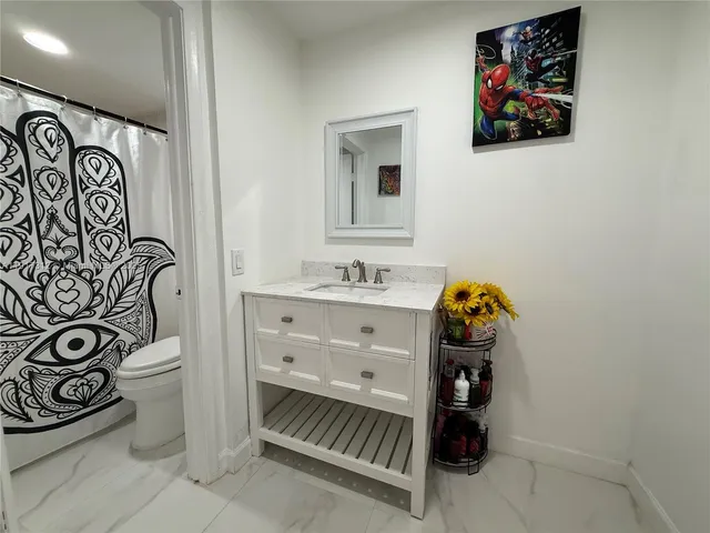 a bathroom with a sink a vanity and a mirror