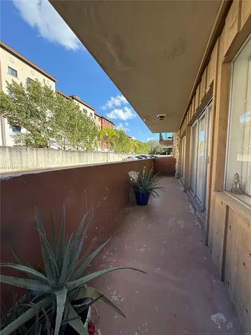 a view of a terrace with furniture and a backyard