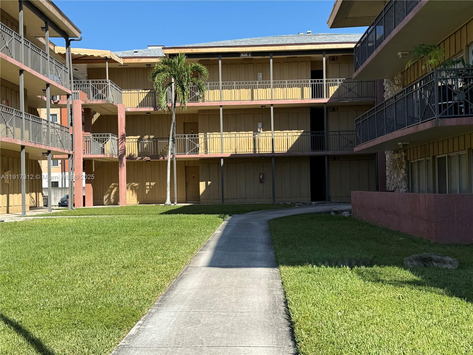 4850 Southwest 63rd Terrace, Unit 312 Davie, FL 33314 - Photo 25 of 27 front view of a house with a yard