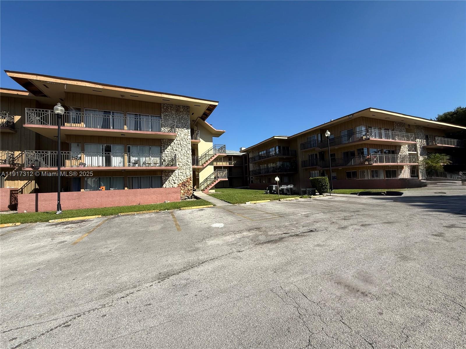 4850 Southwest 63rd Terrace, Unit 312 Davie, FL 33314 - Photo 27 of 27 a front view of a house with a yard