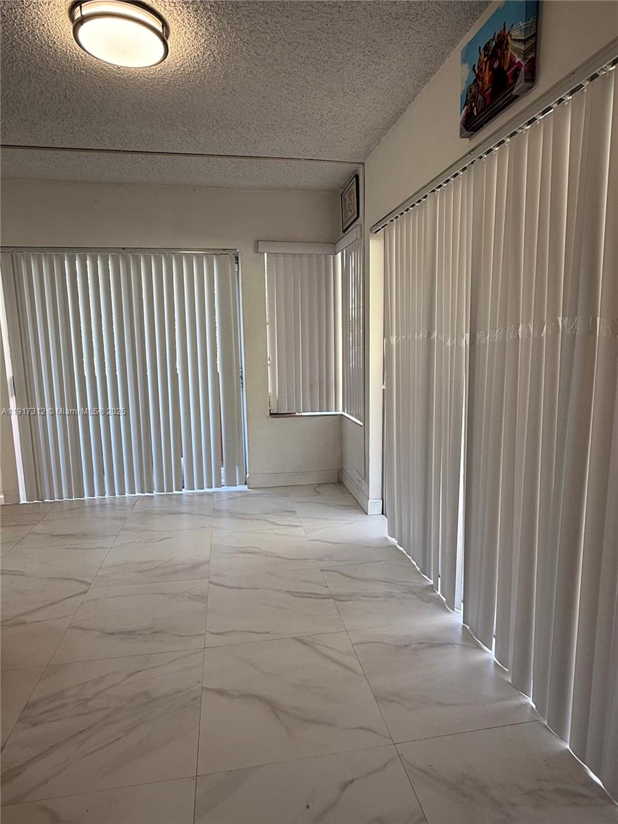 4850 Southwest 63rd Terrace, Unit 312 Davie, FL 33314 - Photo 10 of 27 a view of an empty room with wooden floor