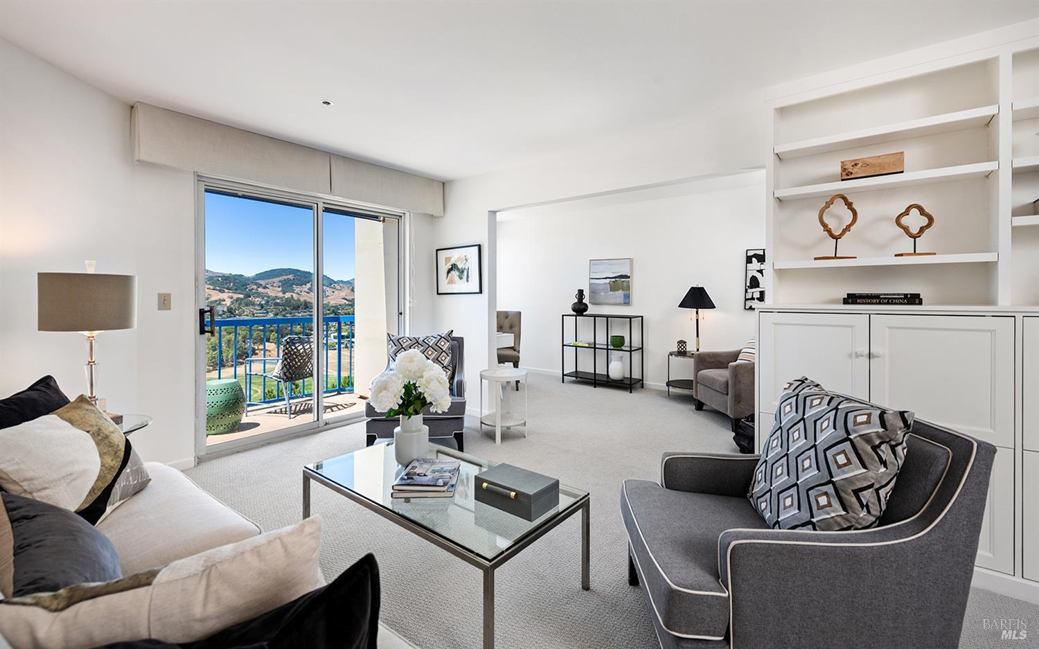 a living room with furniture and a large window