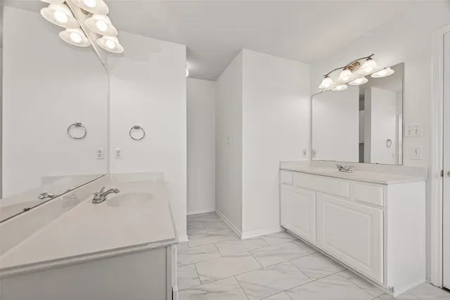 a bathroom with 2 sink and a mirror