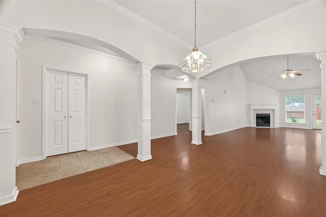 a view of a livingroom with wooden floor and a ceiling fan