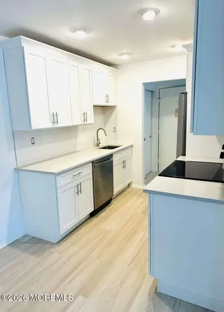 a large kitchen with cabinets and stainless steel appliances