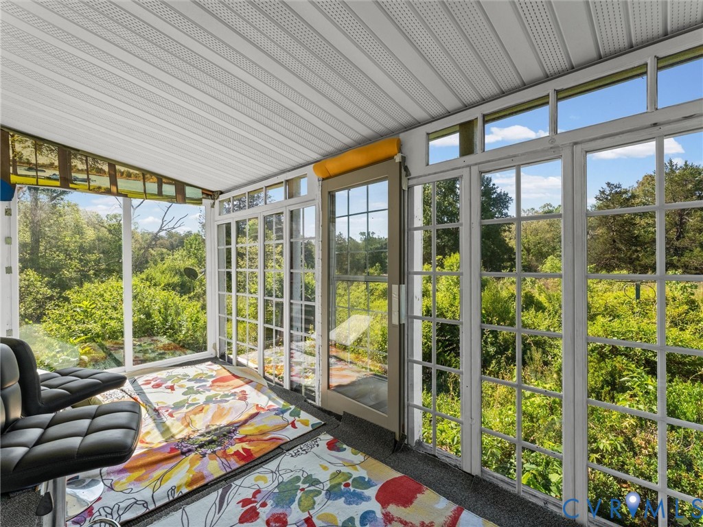 265 Signboard Road Bumpass, VA 23024 - Photo 33 of 39 Sunroom featuring extensive window panels, an exte