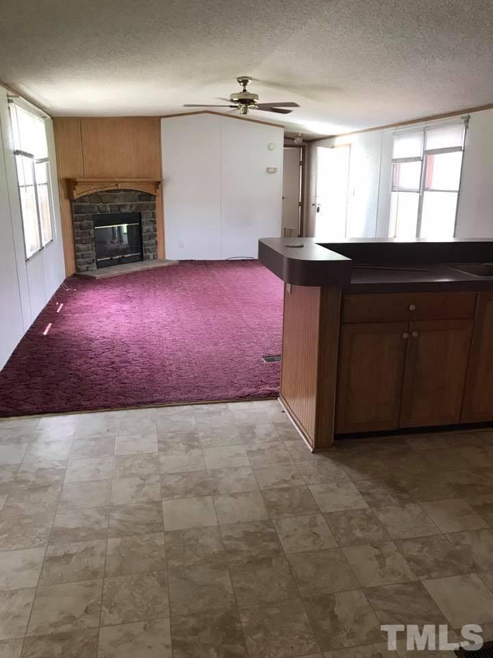 1750 Antioch Church Road Timberlake, NC 27583 - Photo 3 of 10 a kitchen with granite countertop a sink stove and cabinets