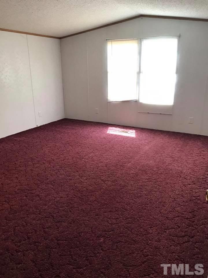 1750 Antioch Church Road Timberlake, NC 27583 - Photo 7 of 10 an empty room with a window