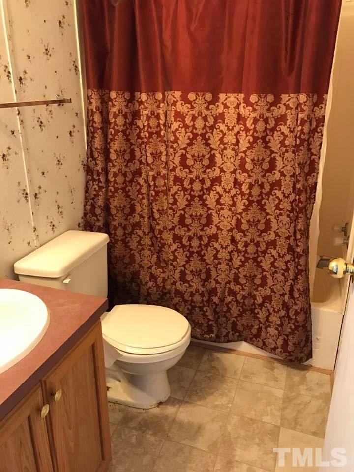 1750 Antioch Church Road Timberlake, NC 27583 - Photo 8 of 10 a bathroom with a toilet and a shower curtain