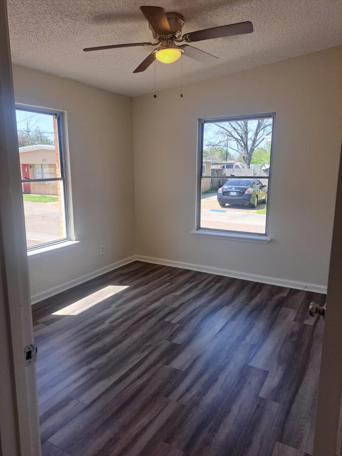 3357 Frick Road, Unit 2 Houston, TX 77086 - Photo 4 of 9 Bedroom 1 is filled with natural light, featuring ceiling fans for added comfort, no carpet, and a spacious layout.