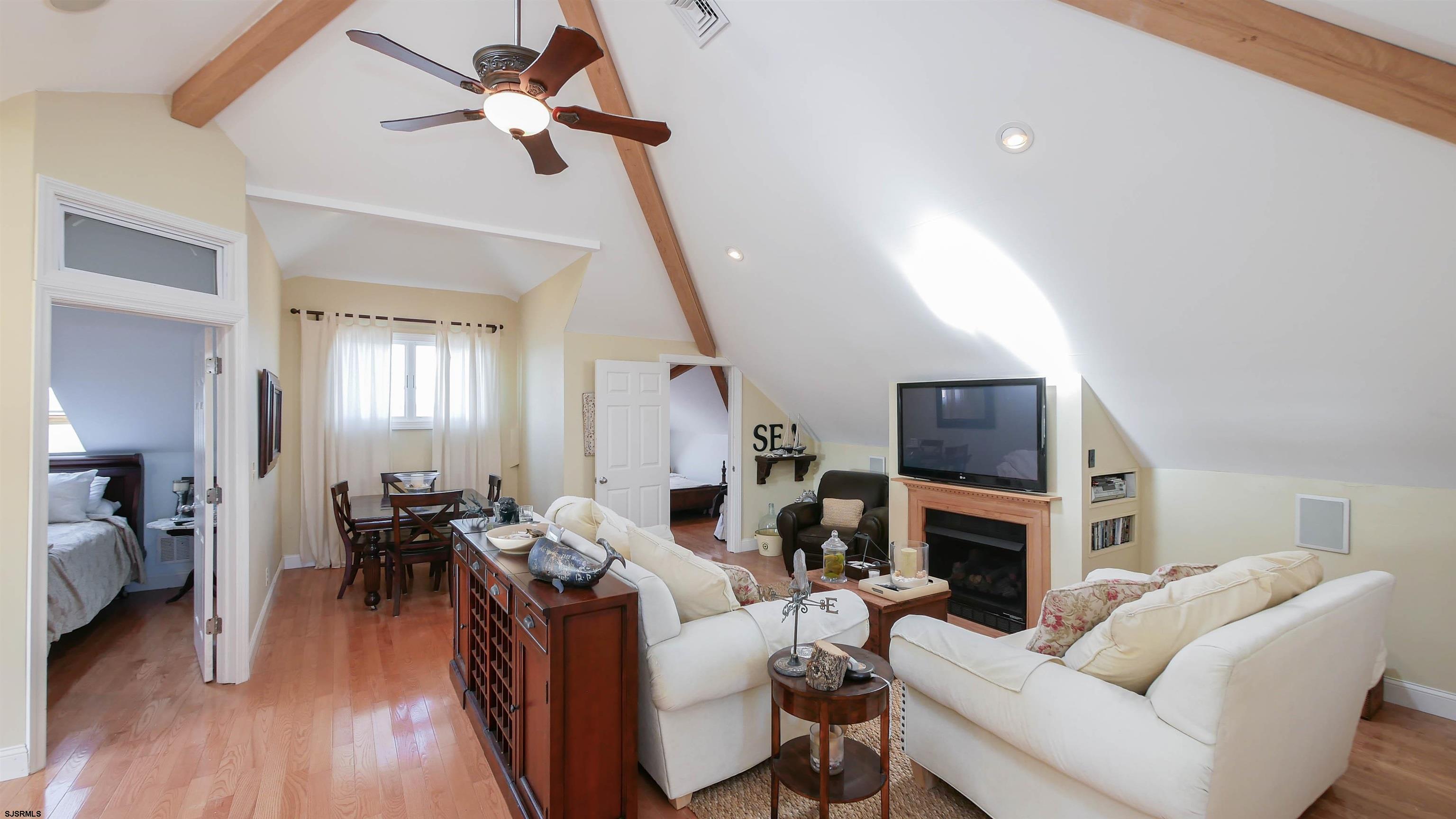 2070 West Riverside Drive Atlantic City, NJ 08401 - Photo 28 of 40 a living room with furniture a fireplace and a wooden floor