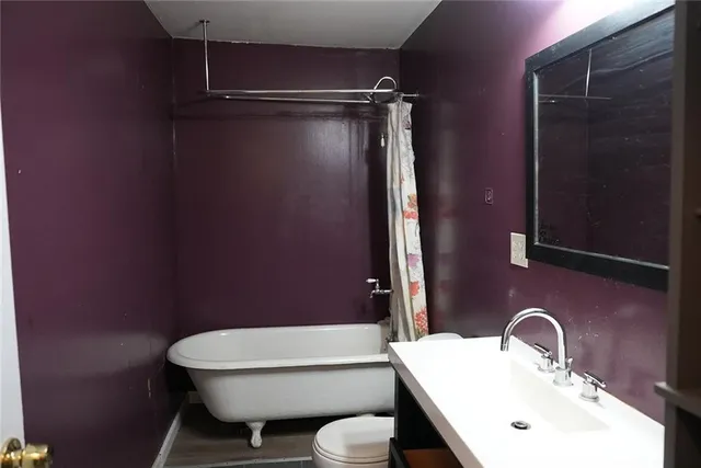 a bathroom with a sink mirror and toilet