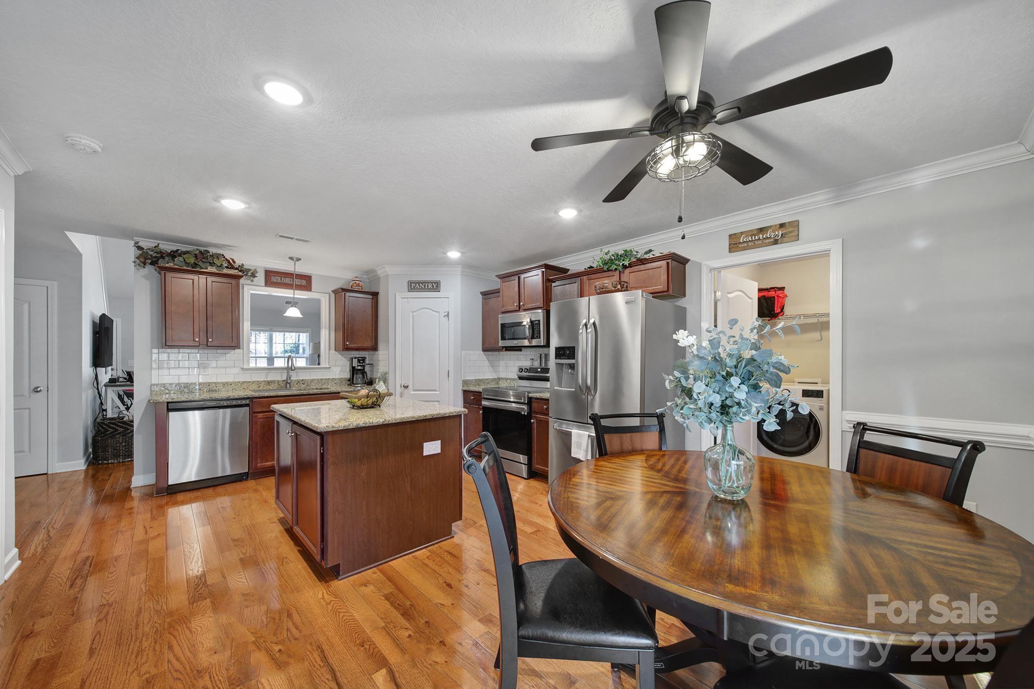 2045 Roadrunner Road Clover, SC 29710 - Photo 11 of 38 a view of a dining room with furniture and wooden floor