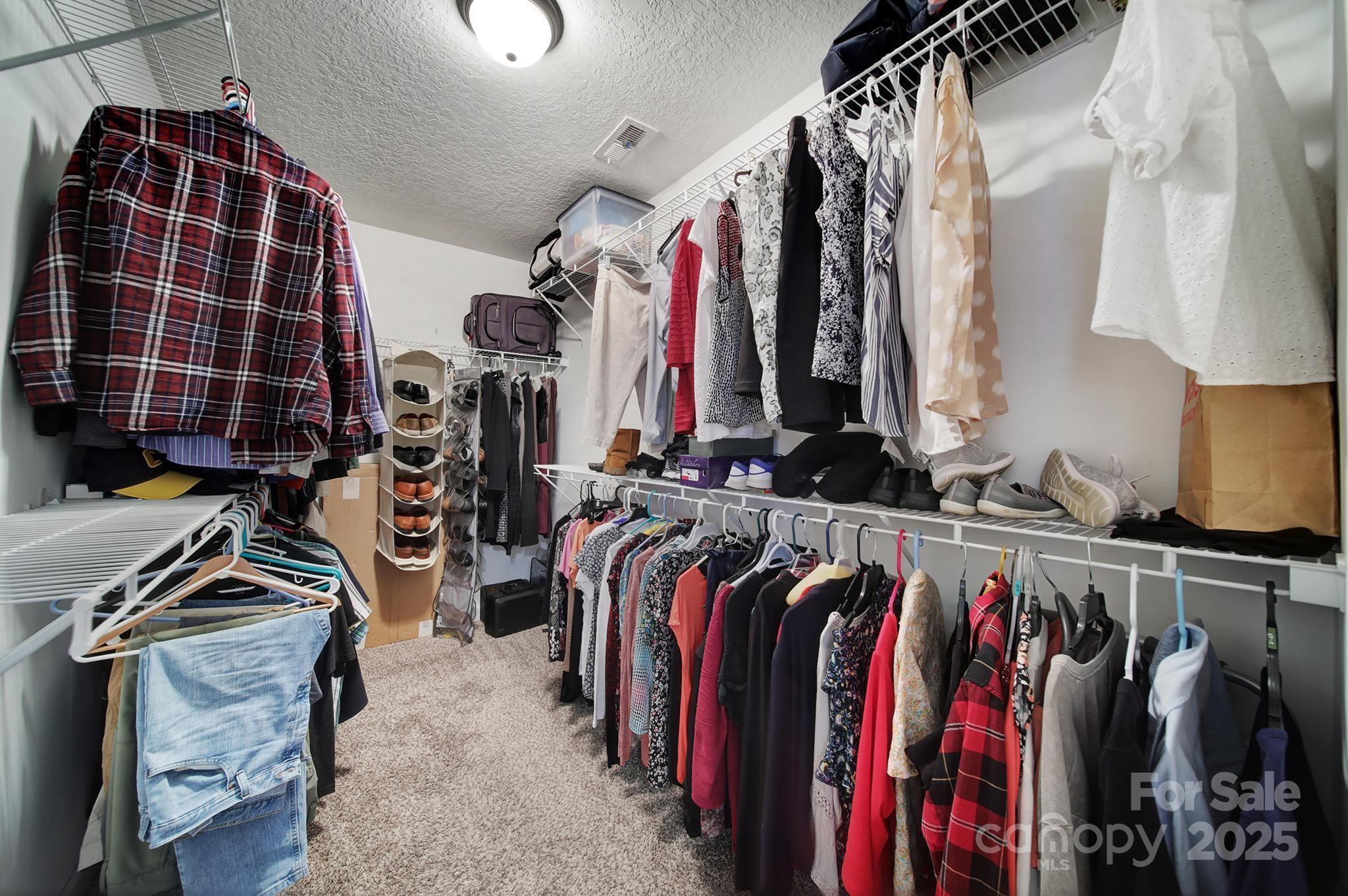 2045 Roadrunner Road Clover, SC 29710 - Photo 14 of 38 a view of walk in closet with clothes and shoes