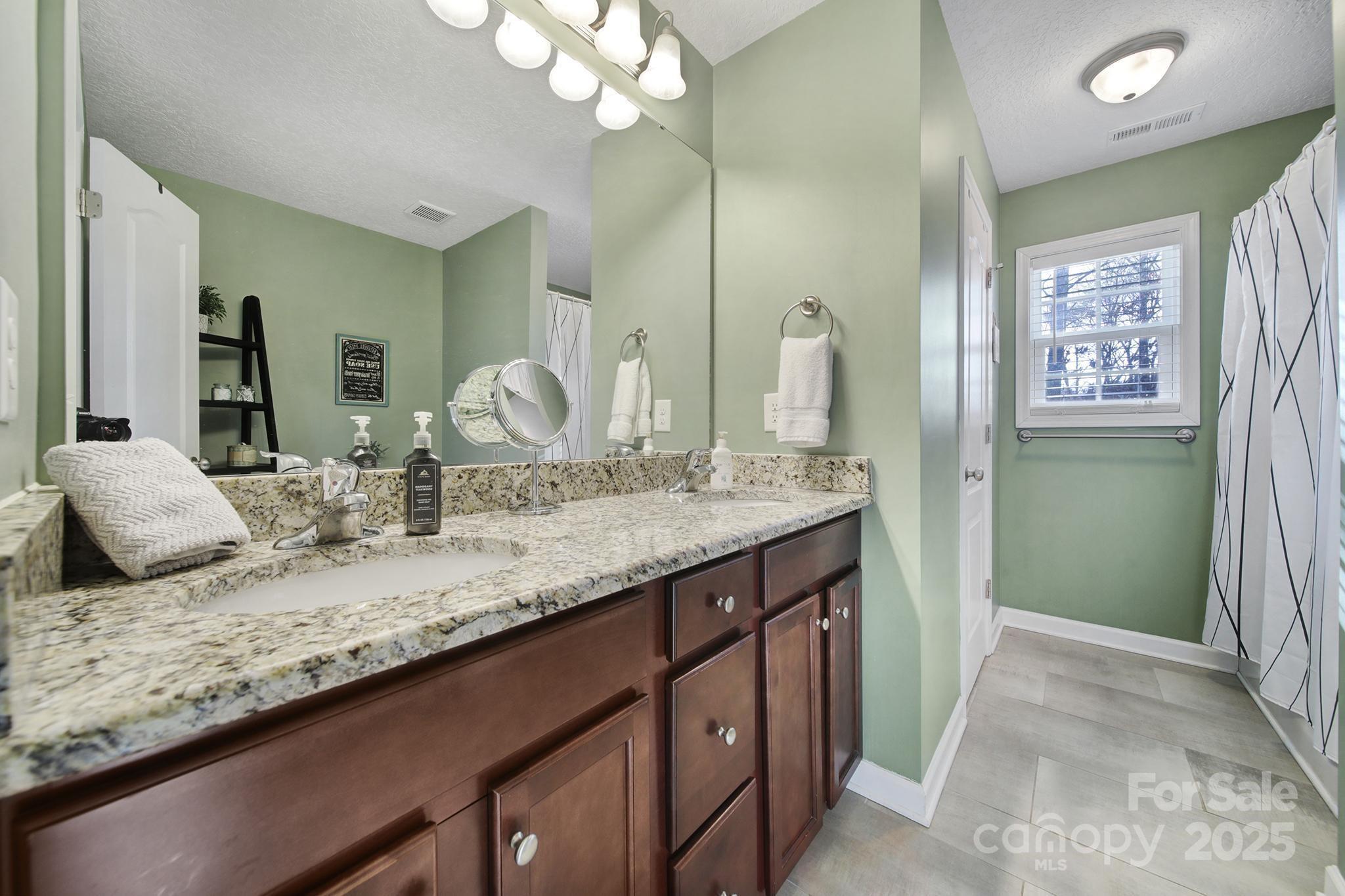 2045 Roadrunner Road Clover, SC 29710 - Photo 16 of 38 a bathroom with a granite countertop sink and a mirror