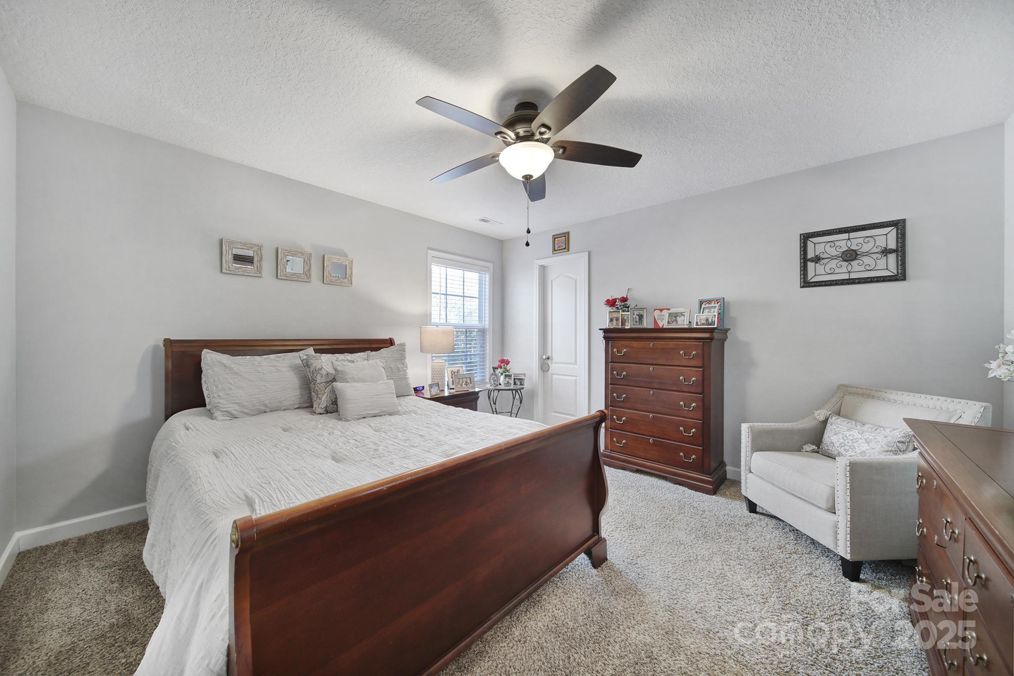 2045 Roadrunner Road Clover, SC 29710 - Photo 17 of 38 a bedroom with a bed and a chandelier