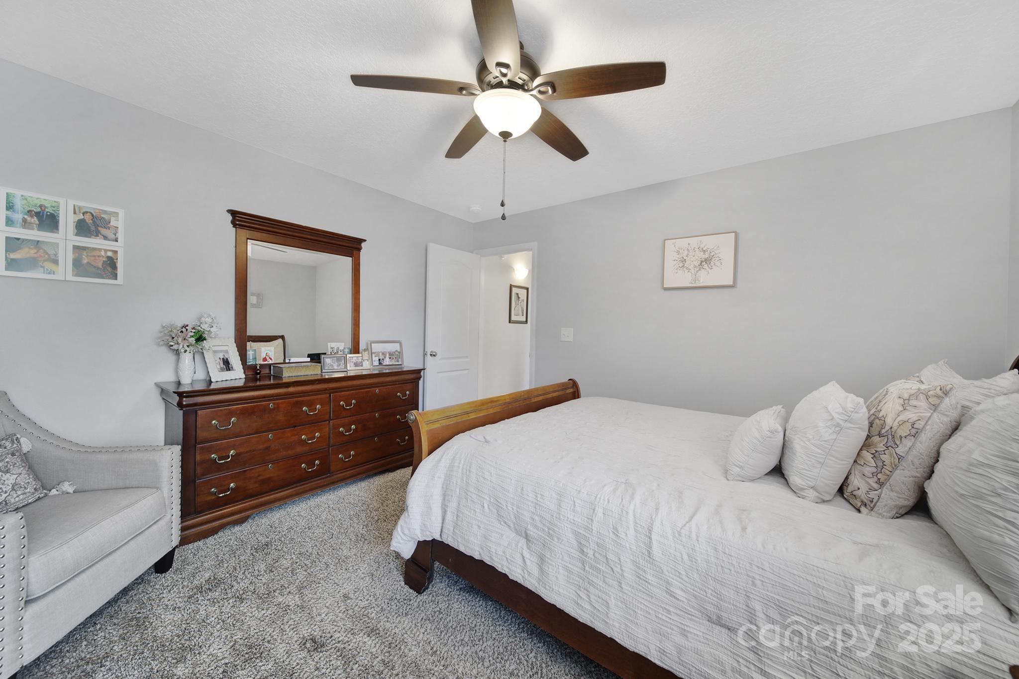 2045 Roadrunner Road Clover, SC 29710 - Photo 18 of 38 a bedroom with a bed and a mirror on dresser