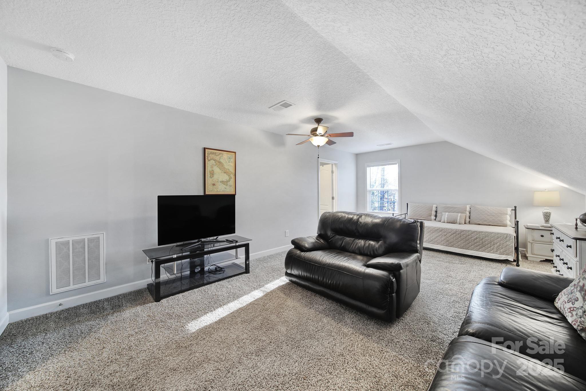 2045 Roadrunner Road Clover, SC 29710 - Photo 22 of 38 a living room with furniture and a flat screen tv