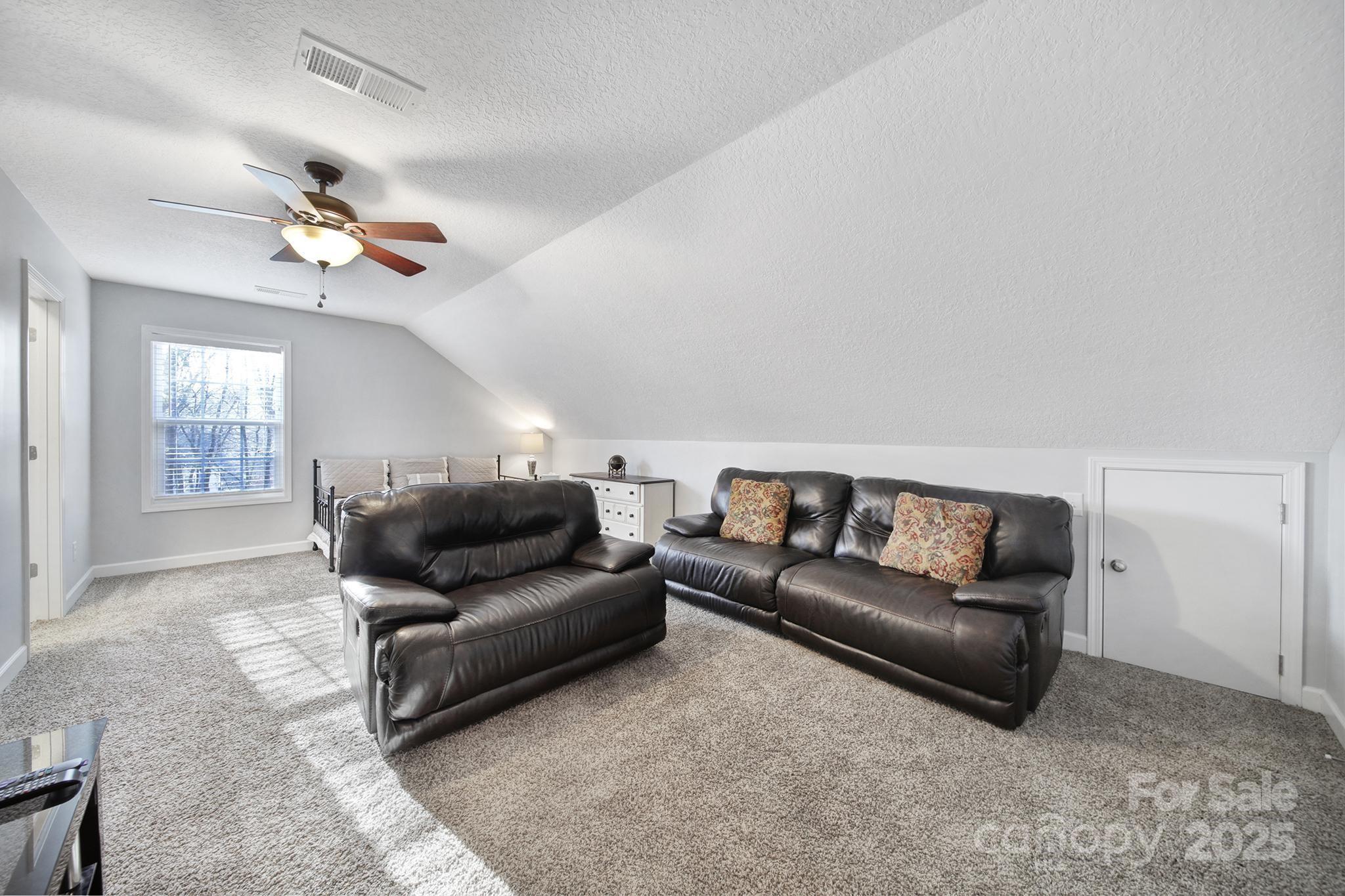2045 Roadrunner Road Clover, SC 29710 - Photo 23 of 38 a living room with furniture and a ceiling fan